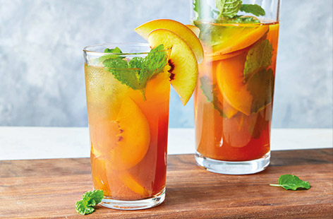 Make the most of summer stone fruit with this fragrant update on a classic iced tea. Fresh peaches are infused with vanilla chai tea for a refreshing treat. Serve over ice with fresh mint for a cool summer spritz. 