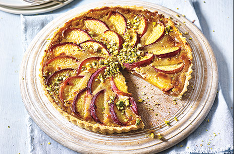 The sweetest peaches, crumbly pastry and creamy custard make this pretty fruit tart the ultimate summer pud