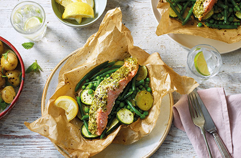 This simple pesto salmon recipe is the ultimate hassle-free meal. A green veg medley of courgettes, peas and green beans is wrapped in parchment with salmon fillets and fresh pesto and all roasted together for a vibrant summer dinner.