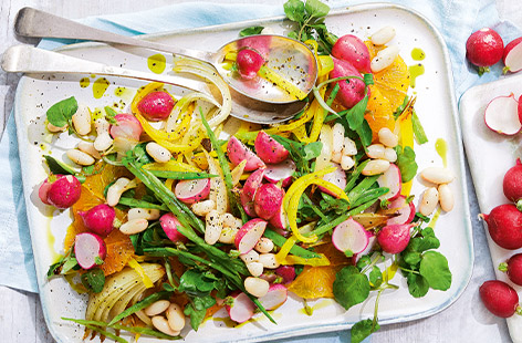 Yellow peppers, pink radishes and fresh orange combine in this super colourful vegan salad. Roasting the radishes gives a delicious charred flavour to this light lunch, and everything is drizzled with a zesty orange dressing to finish.