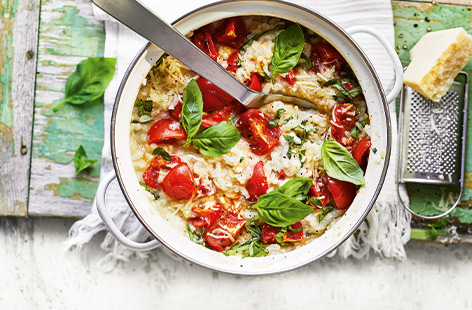 This simple summer risotto recipe is a perfect vegetarian midweek meal for all the family. Sweet roasted tomatoes, melting cheese and basil give a bright, fresh flavour for a delicious spin on this Italian classic.