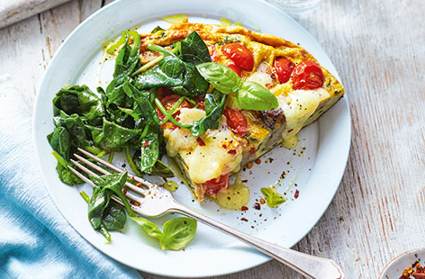 Eggs aren't just for breakfast – this hearty frittata recipe with Cumberland sausages, tomatoes and spinach makes a great family dinner idea