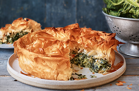 In this seasonal spin on the traditional recipe, try swapping spinach for zesty British-grown spring greens and bake the whole dish into a crunchy, filo-topped pie