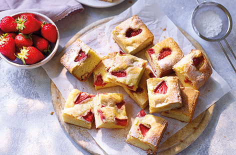 These strawberry blondies are the ultimate summer holiday baking project to indulge a sweet tooth. Rich, fudgy white chocolate blondies are topped with juicy sliced strawberries for a crowd-pleasing bake – slice into squares and pack up for picnics.