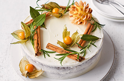 Transform classic Christmas cake into a simple yet stunning centrepiece with beautiful rustic decorations, sweet amaretto-spiced icing, and an almond-encrusted marzipan pinecone
