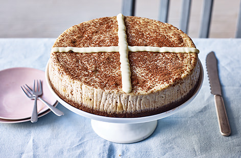 Celebrate Easter with this festive, hot cross bun spin on a classic cheesecake. There's no buns involved, just sweet spices and raisins and the cake is marked with a chocolate cross.