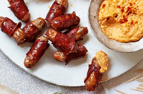 Great Christmas canapés don't have to be complicated – these tasty chipolatas wrapped in spicy chorizo are perfect for serving to your party guests alongside some paprika-dusted red pepper houmous. A brilliant Christmas party food idea