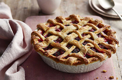 This pretty latticed pie is sure to go down a treat with the family, with golden buttery pastry and a sweet mixed berry filling. A few clever shortcuts make this generous pie an easy weekend treat - serve with plenty of custard or ice cream!