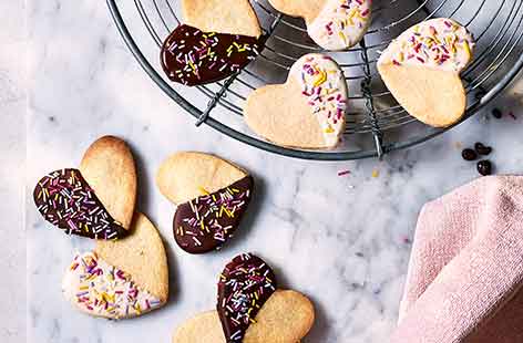 Bake a batch of pretty funfetti hearts to give to your Mum this Mother's Day - the buttery shortbread dipped in chocolate and decorated sprinkles make the perfect afternoon treat.