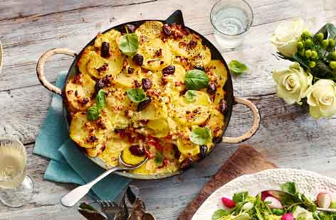 Put a Mediterranean twist on a comfort food classic with this Greek potato gratin. Crumbled feta, saffron, red peppers and olives are added to the creamy potatoes – serve with simple roast chicken for a delicious addition to a Sunday roast. 