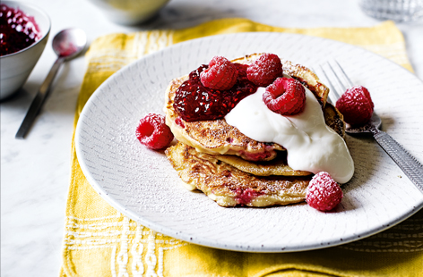 Try something different on Pancake Day with a stack of light and fluffy Russian syrniki pancakes. Flavoured traditionally with cottage cheese and honey, juicy raspberries are stirred through the batter before serving.