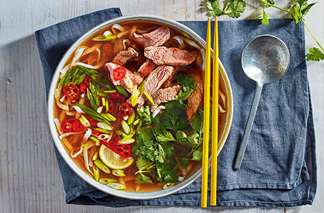 This Vietnamese-inspired quick beef pho is a speedy midweek meal that can be made in under 30 minutes. Freezing the steak makes it easy to slice very thinly, which helps it cook quickly in the spiced broth for perfectly tender results.
