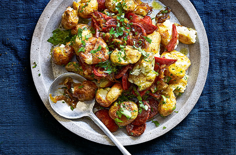 Spice up your roasties with these crispy smashed potatoes and chorizo. With caramelised shallots, salty chorizo and golden roast potatoes, this irresistible side dish is the perfect addition to a Spanish-inspired feast.