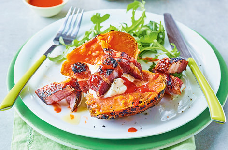 Sweet potatoes get right up close with the coals in this wonderfully smoky supper. Top with crisp pork belly slices, a dollop of crème fraîche and a drizzle of fiery sriracha for a delicious, healthy barbecue spin on a jacket potato