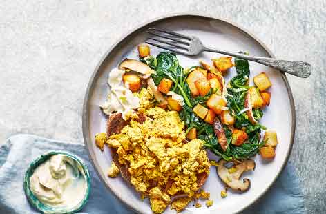 This hearty vegan brunch is packed with veg to see you through the morning. Mushrooms, potato and leek are caramelised into a crisp hash, then finished with fresh spinach and a clever tofu scramble. 