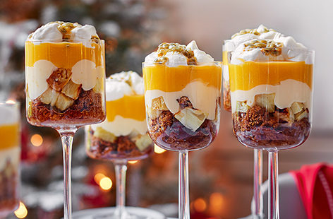 These individual trifles, perked up with a shot of ginger wine and layered with Jamaican ginger cake and tropical fruits, are the perfect ending to Christmas dinner
