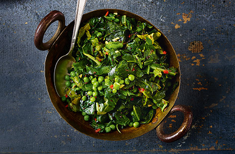 This vegan Indian side dish is perfect for sharing on curry night. Ready in under 15 minutes, this vibrant stir-fry of greens and peas has a real kick from fresh chilli and ginger. 