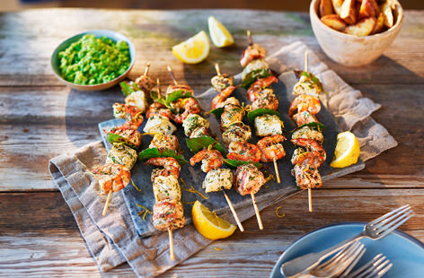 Marinated in a mix of lemon juice, garlic and green herbs, these fish and king prawn kebabs taste incredible served straight off the barbecue with a scattering of fresh lemon zest