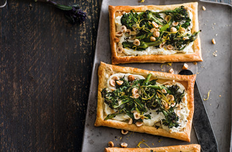 Seasonal purple sprouting broccoli is sweet in flavour and lends such a pretty vibrancy to dishes. Top puff pastry with creamy goat's cheese, toasted hazelnuts and roasted broccoli for a delicious lunch on the go.