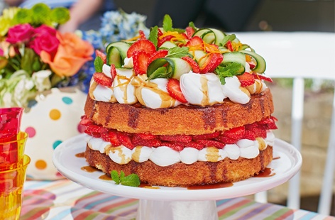 A showstopping summertime bake – Pimm's-soaked sponge sandwiched with mascarpone cream and topped with fresh strawberries and cucumber