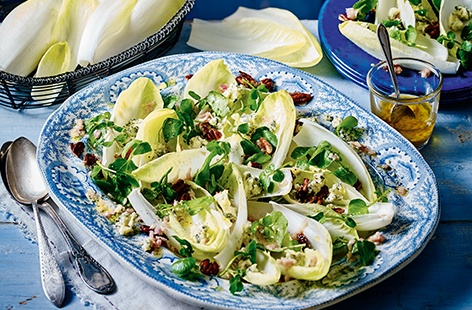 This green, leafy salad is packed with crumbly blue cheese, sugared pecans and crisp chicory, which brings a wonderful sharpness to this flavoursome dish. With a drizzle of honey and a mustard and shallot dressing, this rustic salad can be made in minutes