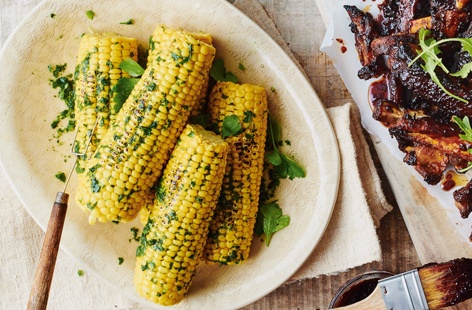 Everyone's favourite barbecue side, corn on the cob is given a little extra fire in this flavour-packed veggie recipe. Rubbed with a fragrant medley of herbs, chilli, garlic and creamy butter, before being lightly charred on the grill, it's sure to please 