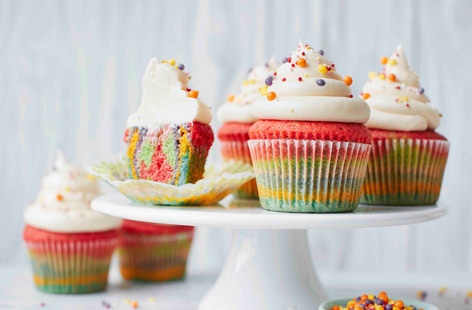 Sure to go down a treat at parties, these gorgeous rainbow cupcakes feature six layers of colourful sponge topped with a rich buttercream icing and showers of sprinkles