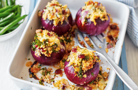 A delicious spin on stuffed peppers, sweet red onions are loaded with hearty bulgur, nutty celeriac, fragrant kale and creamy Stilton in this delicious dinner for two