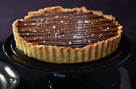 An elegant and sumptious salted caramel tart with a rich chocolate ganache topping, perfect for a show-stopping dessert