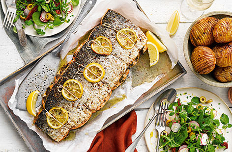 Delicate salmon is given a delicious lift when roasted with a mix of peppercorns, coriander seeds, juniper berries and plenty of fresh herbs. Serve with gorgeous hasselback potatoes, baked until golden and fluffy
