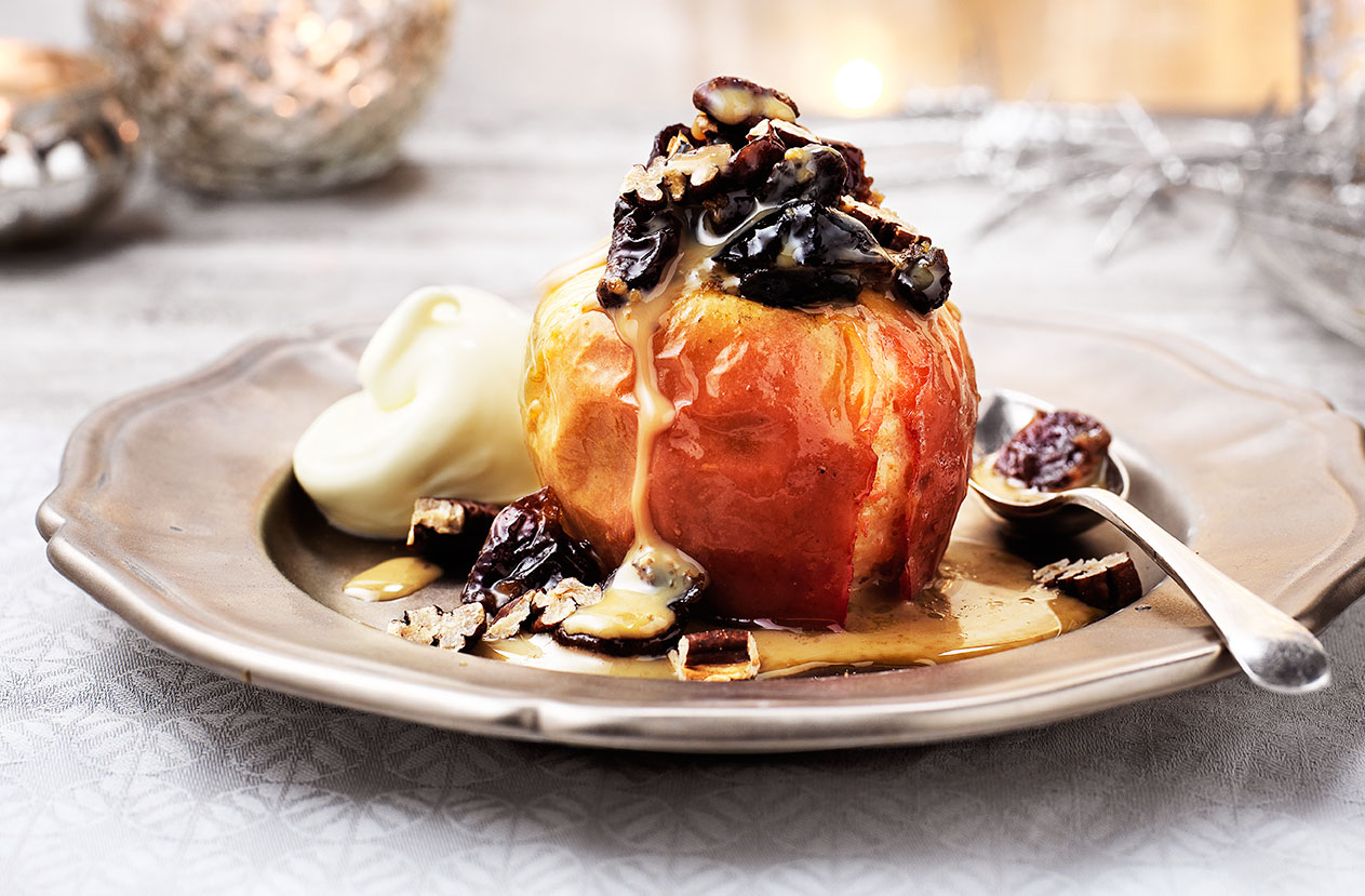 Serve up this show-stopping dessert packed with warming winter flavours to round off your special feast. Crisp cox apples are filled with salted caramel, baked and topped with liqueur soaked dried fruits