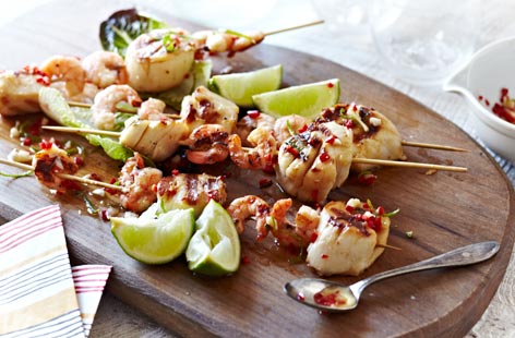 Impress your barbecue guests with these delicious seafood kebabs. The zingy lime, garlic and chilli dressing really accentuates the strong flavours of prawns and scallops. Add a little more chilli if you're a fan of spice.