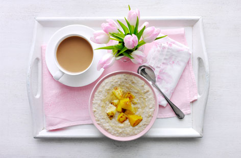 Bun in the oven breakfast in bed: Treat a tired mum to this delicious breakfast of slow-cooked coconut porridge with warm tropical fruit