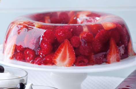 A refreshing and gorgeous-looking dessert, bursting with healthy summer berries. To make, fresh strawberries and rasberries are set in a sweet homemade jelly overnight in the fridge. Serve with a dollop of whipped cream.