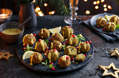 Add some extra veg to classic falafel with this easy broccoli falafel recipe. A super simple canapé, these fluffy baked falafel are simply blitzed together before being rolled into balls, baked and topped with a drizzle of houmous.