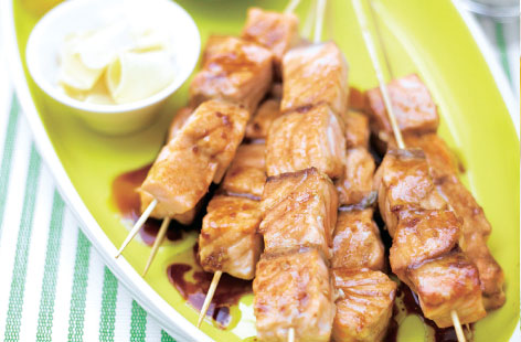 Salmon teriyaki kebabs take no time to prepare and cook in minutes. Skewered chunks of salmon are brushed with a garlic, ginger, honey, soy sauce and sesame glaze, then baked under the grill until juicy and cooked-through.