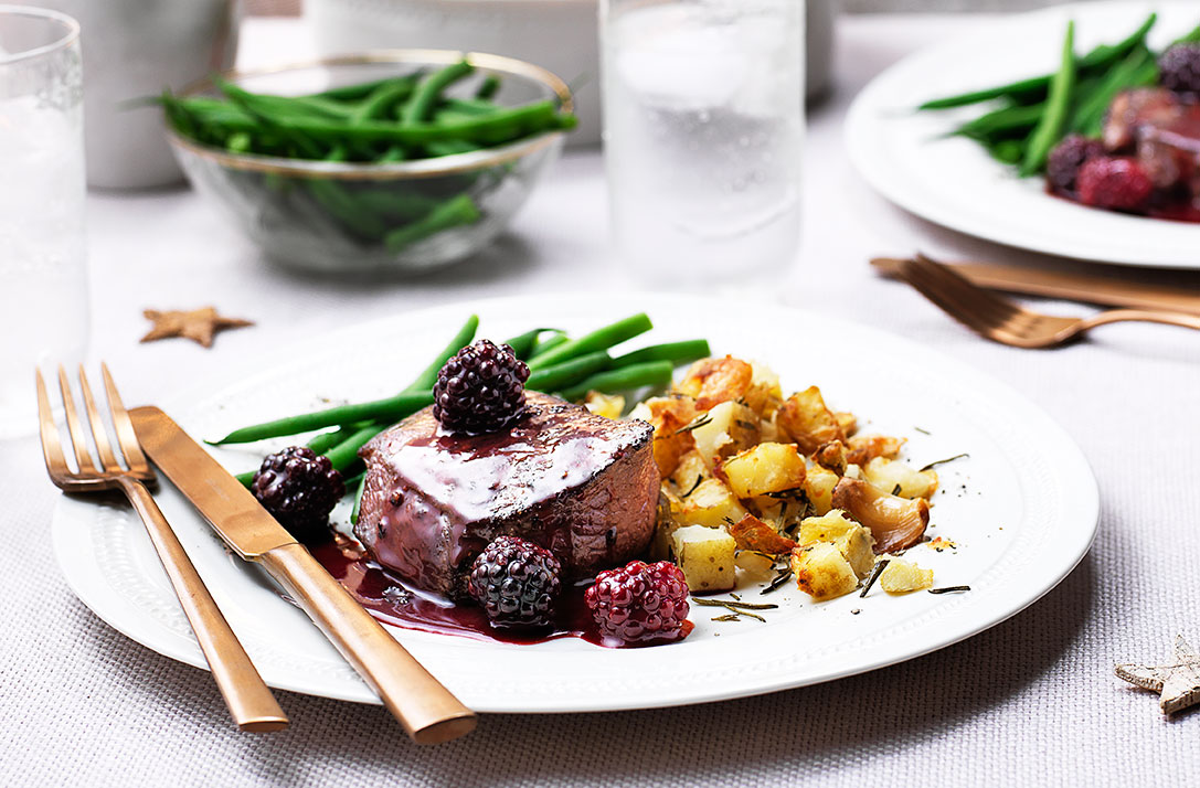 For a truly special supper try this tender venison steak with garlic-roasted potatoes and a rich blackberry sauce