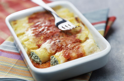 This pasta bake is mouthwateringly creamy and vegetarian to boot. Ricotta, parmesan and wilted spinach are spooned into cannelloni tubes then topped with a herby tomato sauce, and grated mozzarella. Bake until oozing with bubbling cheese.