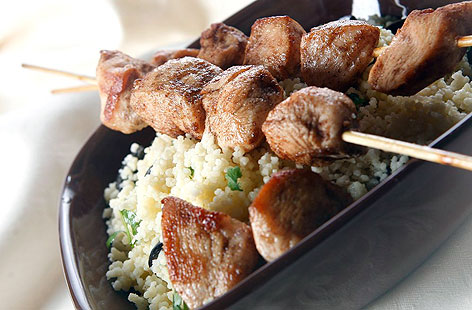 Marinate the chicken for up to an hour with the oil, garlic, ground spices, cayenne and lemon juice mix, then fire up the barbecue or grill. Adding olives and coriander to the couscous adds a real pep.