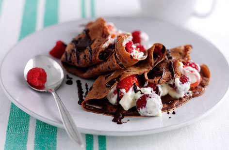 How to make lacy pancakes even better? Add chocolate! These dark cocoa pancakes are filled with custard, berries and a drizzle of melted chocolate for the ultimate Pancake Day treat.