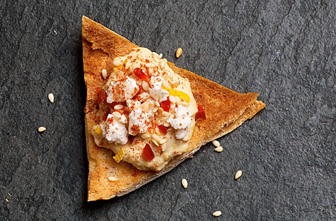 Four pitta breads go a long way with this thrifty party canapé recipe.