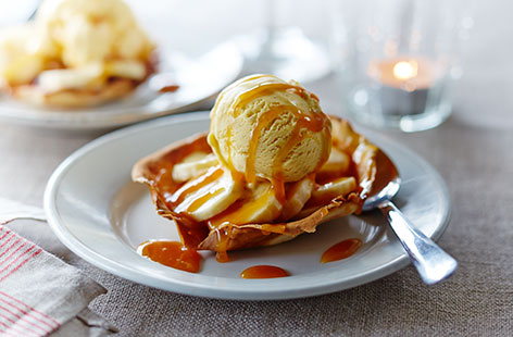 Classic banoffee pie is given a delicious twist in this gorgeous dessert, featuring sliced bananas, vanilla ice cream and silky toffee sauce all packaged up in golden, crispy crêpe baskets
