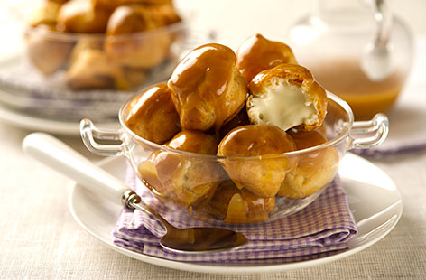 Profiteroles really are the food of the gods. These light, crunchy, and subtly sweet pastry balls are stuffed with a ludicrously delicious cardamom cream and covered with an orange toffee sauce. Assemble them just before serving like a profiterole pro.