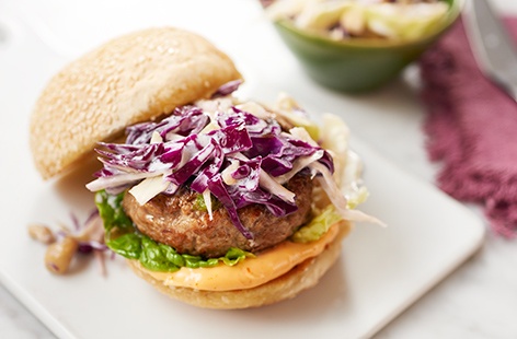 Using many of the same ingredients as classic pork meatballs, this mouthwatering burger features a juicy ginger pork patty, crunchy cabbage and cashew slaw, and zingy sriracha mayo