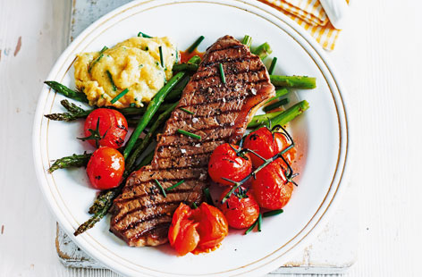 A mouthwatering meal that's perfect for one or two any night of the week - lightly fried beef steak served alongside a creamy cheese and chive polenta with roasted asparagus and cherry tomatoes