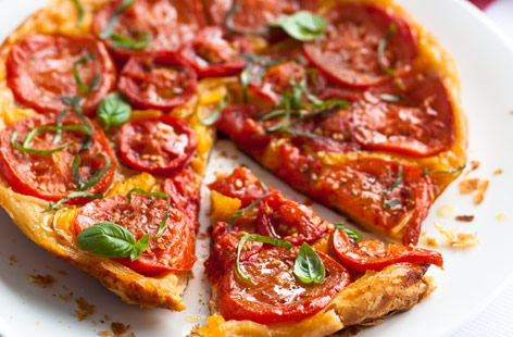 This is an exciting way of using up tomatoes and peppers that are about to turn. Grilling the peppers before they're added to the tart really brings out their sweet, tangy taste. Add fresh basil for a proper flavour of summer.
