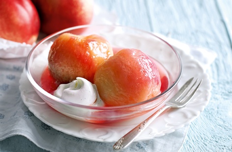 Peaches really are the ultimate stone fruit, and this summery pudding makes the most of them. The peaches are poached in wine with vanilla, lemon zest and sugar, and served with lightly whipped double cream infused with yet more vanilla and sweetened with icing sugar.